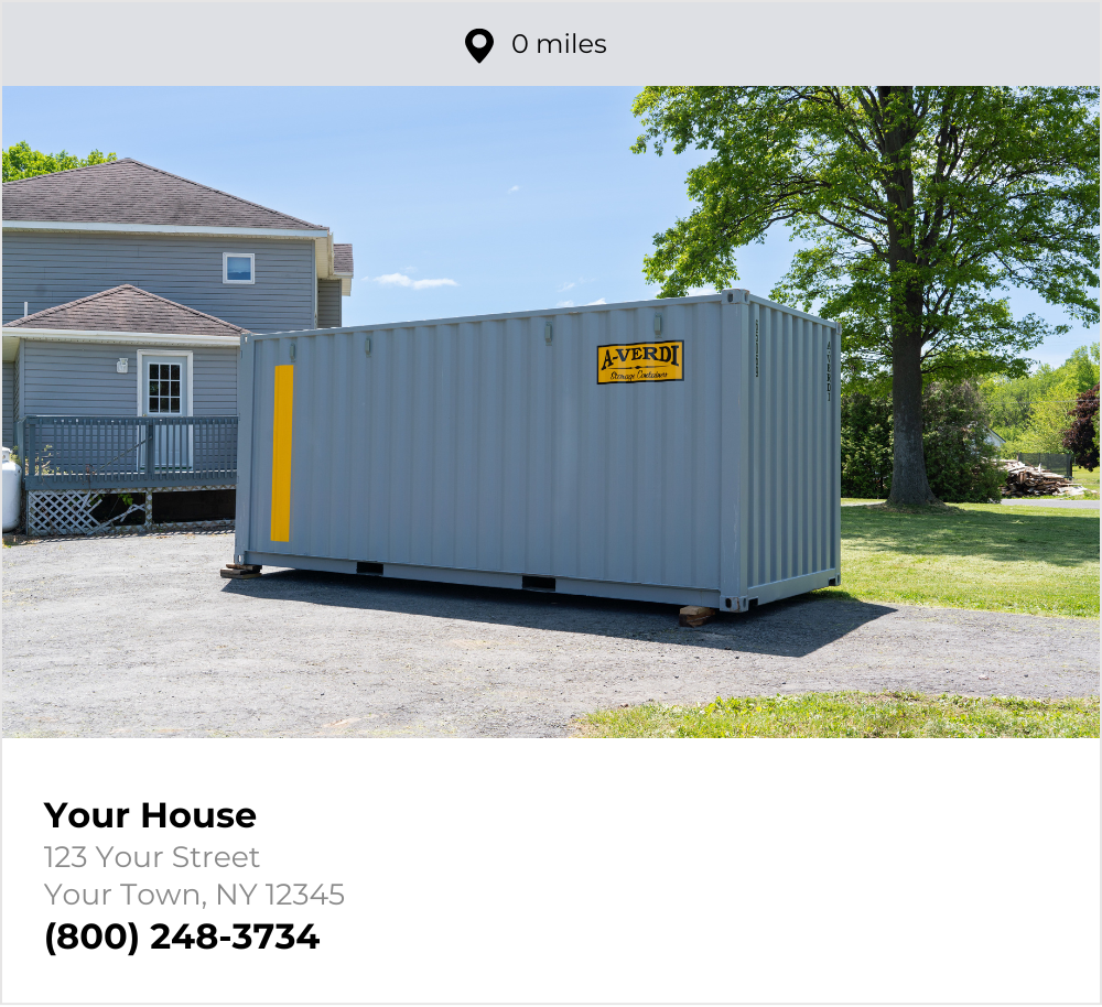A gray A-Verdi storage container placed on a driveway next to a house in a residential neighborhood. The container features the A-Verdi Storage Containers logo and a yellow safety stripe. The house is light gray with white trim, and the yard has green grass and large trees. A caption below the image reads “Your Home, 123 Any Street, Upstate NY” with the phone number (800) 248-3734 and a location pin icon indicating "0 miles."